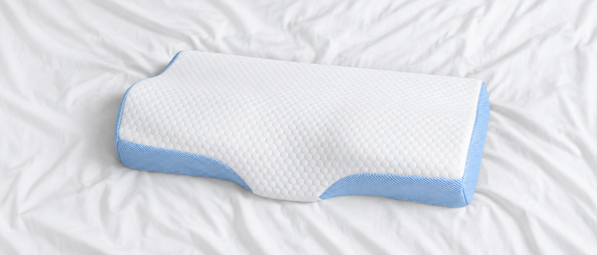 SleepCradle pillow from above on white sheets